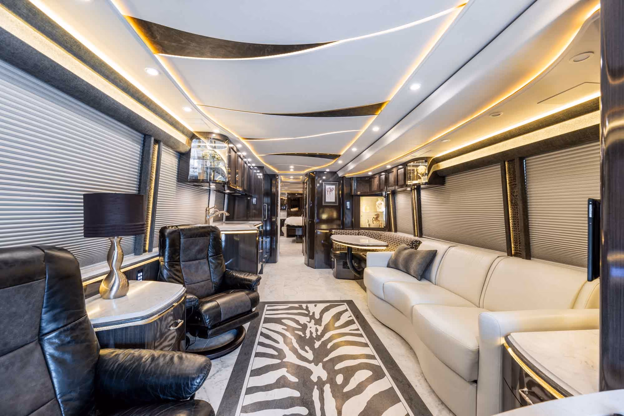 Interior salon of 2021 Marathon Coach 1321 with Carrara tile throughout