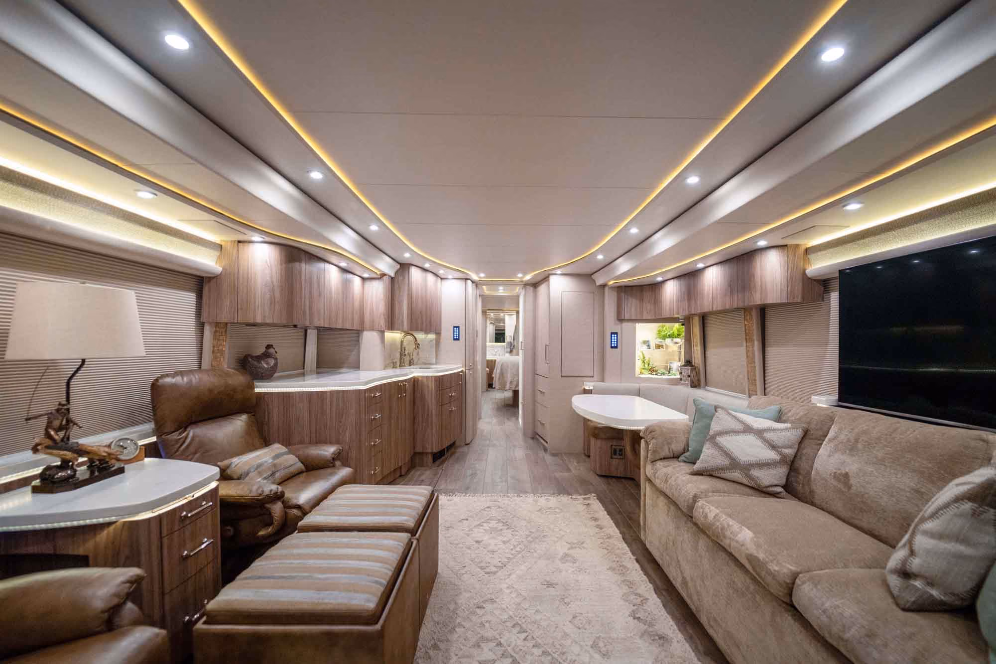 Interior salon of 2019 Marathon Coach 1287 with salon sofa featuring queen air mattress