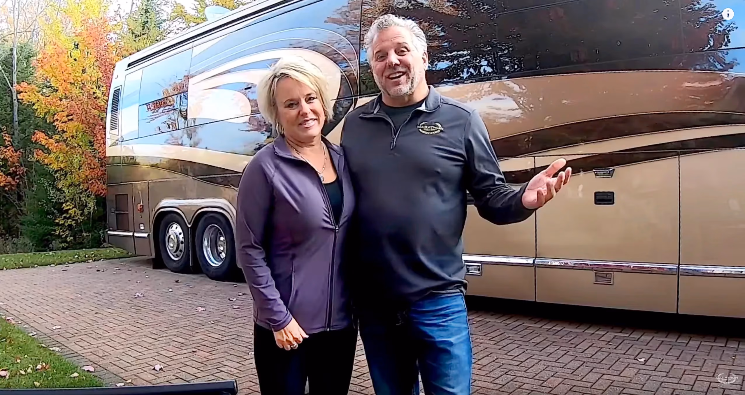 Randy and Dawn standing in front of their Marathon Coach at Hearthside Grove