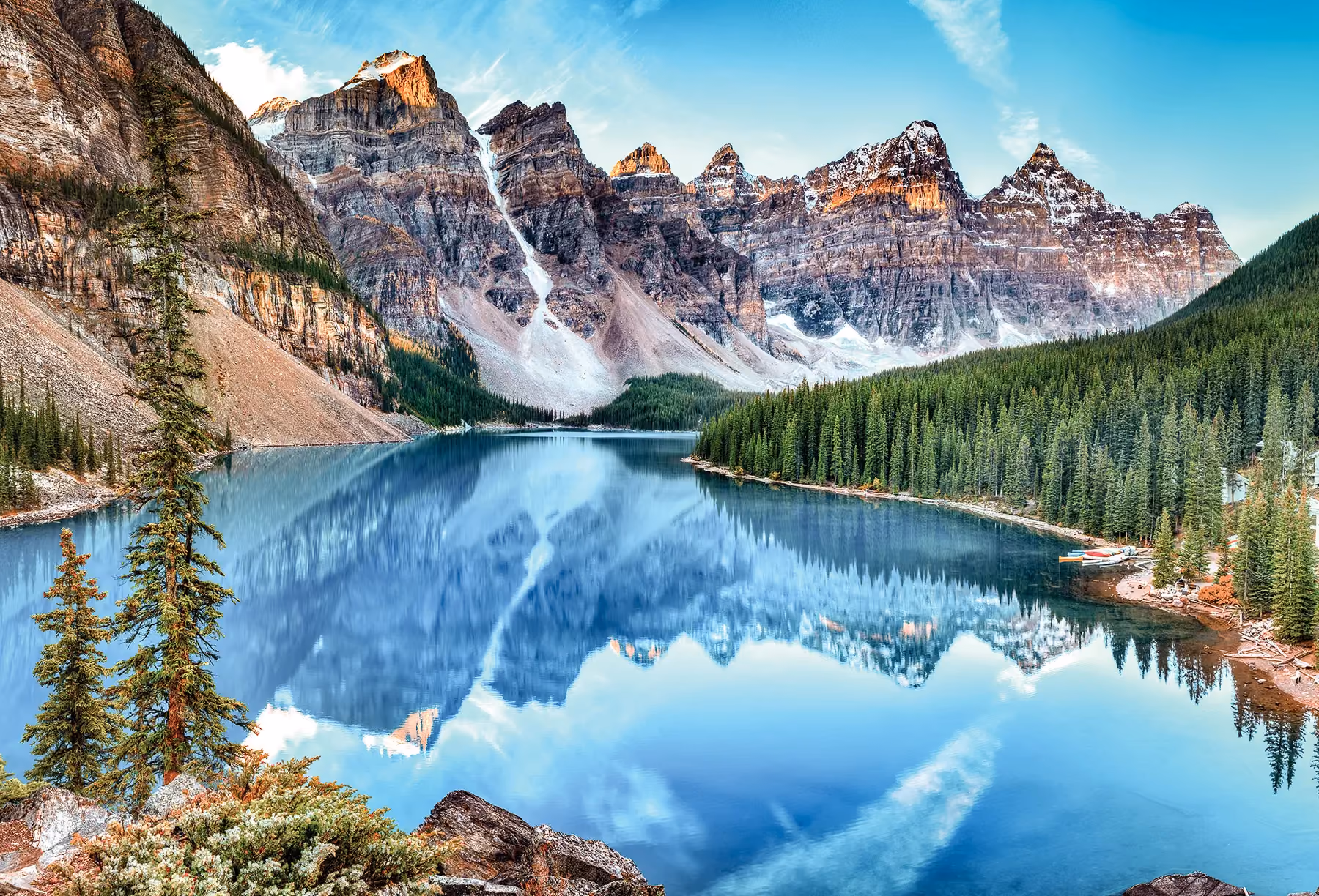 A photo of mountains overlooking a pristine alpine lake