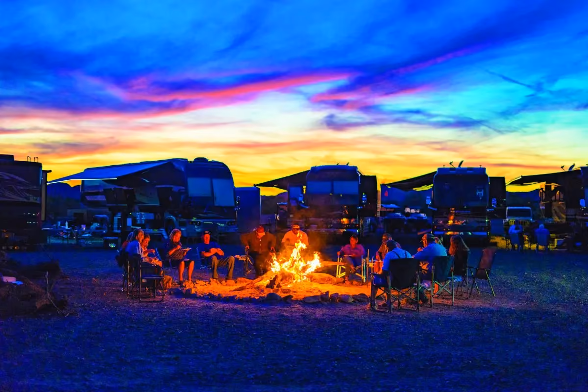 Friends around a bonfire during a beautiful sunset