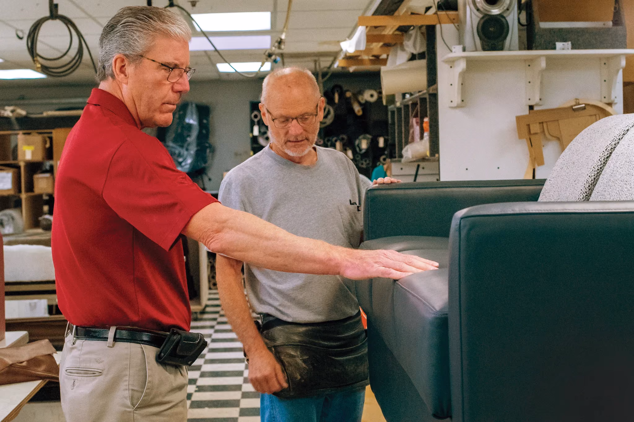 Members of Marathon's Upholstery looking over a Custom Couch