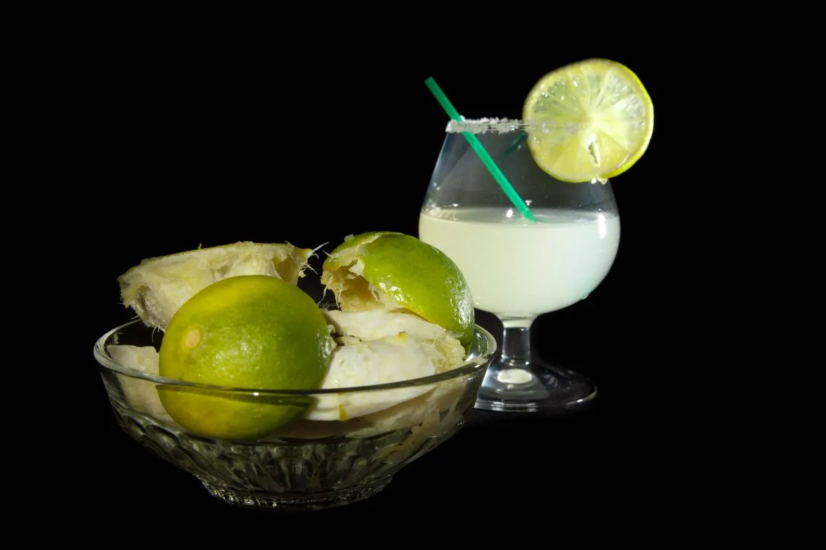 Margarita Cocktail And A Plate Of Squashed Lime