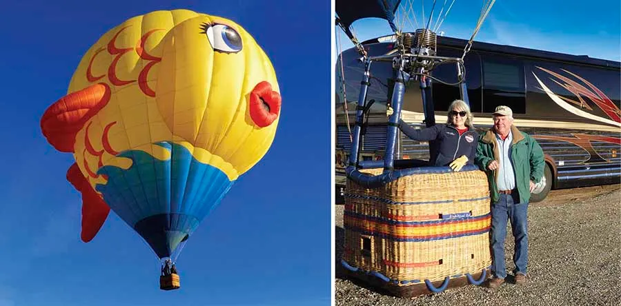 A hot air balloon and 2 people standing with a hot air balloon