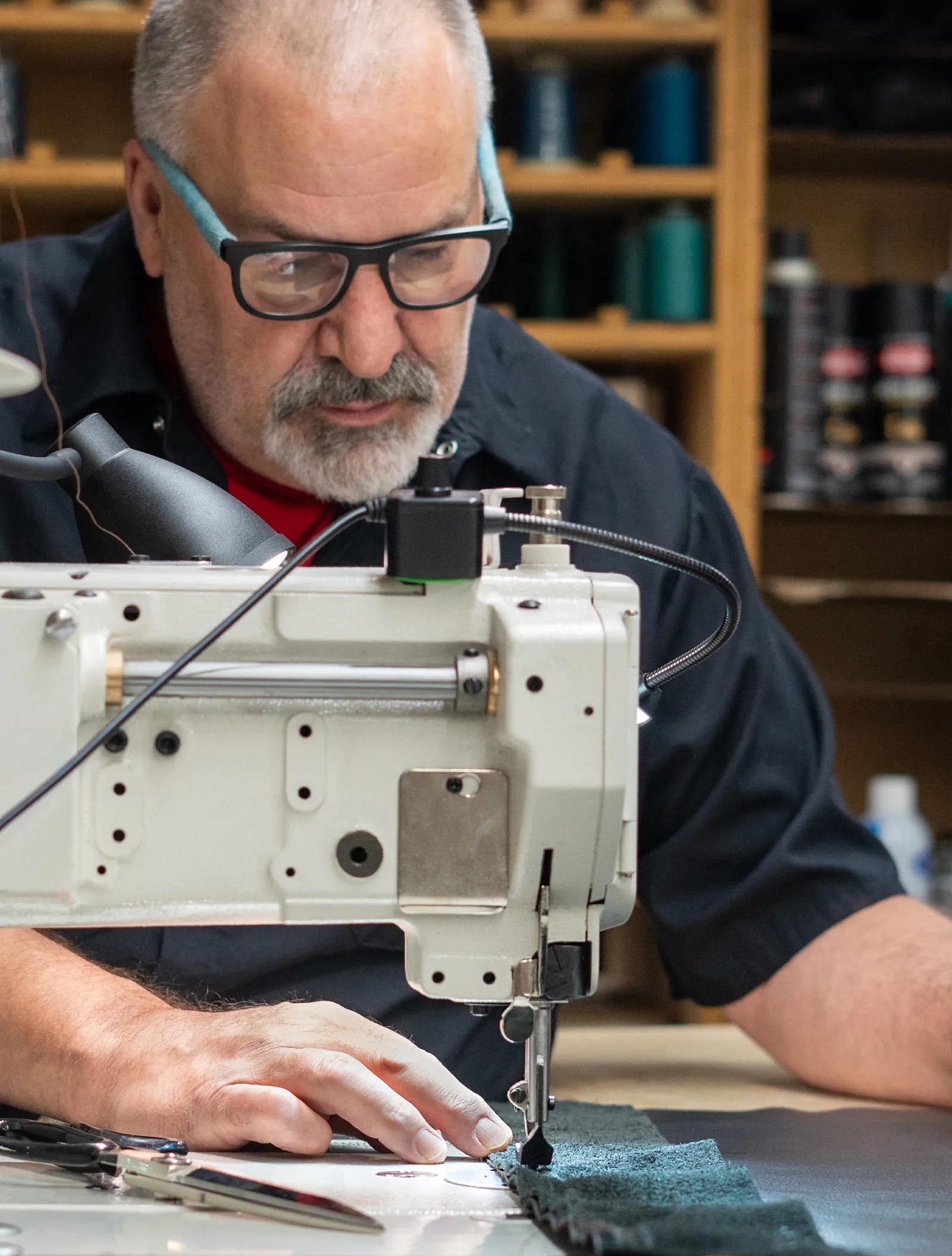 A Marathon Coach employee working on custom upholstery