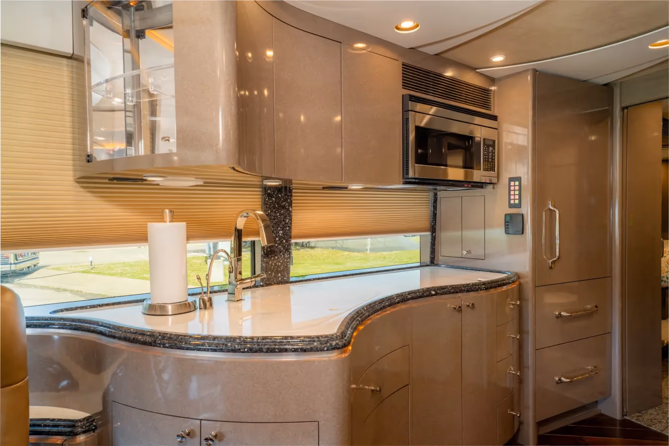 Interior galley kitchen with wood plank flooring in Marathon Coach 1153