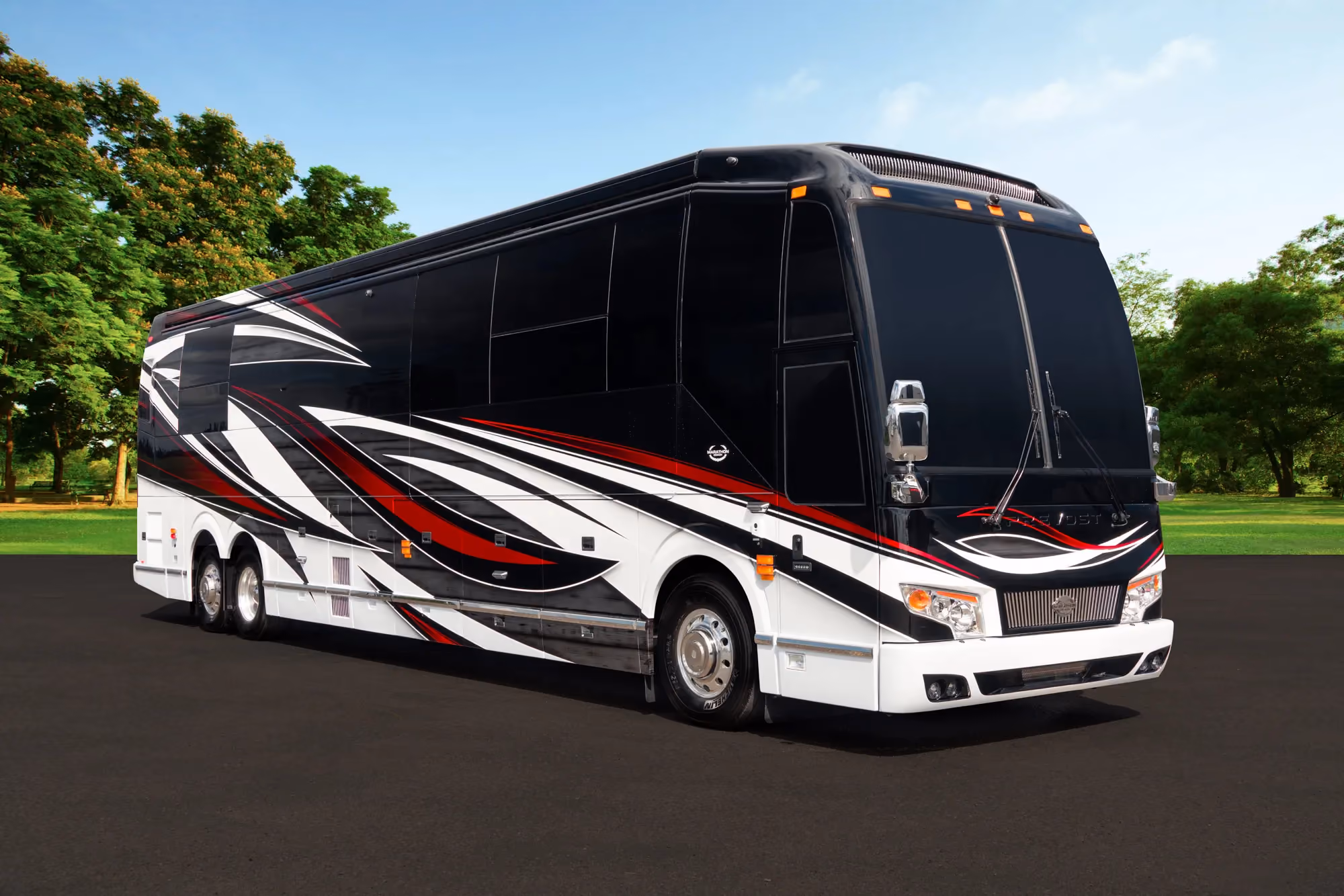 Exterior glamour shot of 2022 Marathon Coach 1354 on Prevost H3-45 chassis with red and white accents on black exterior
