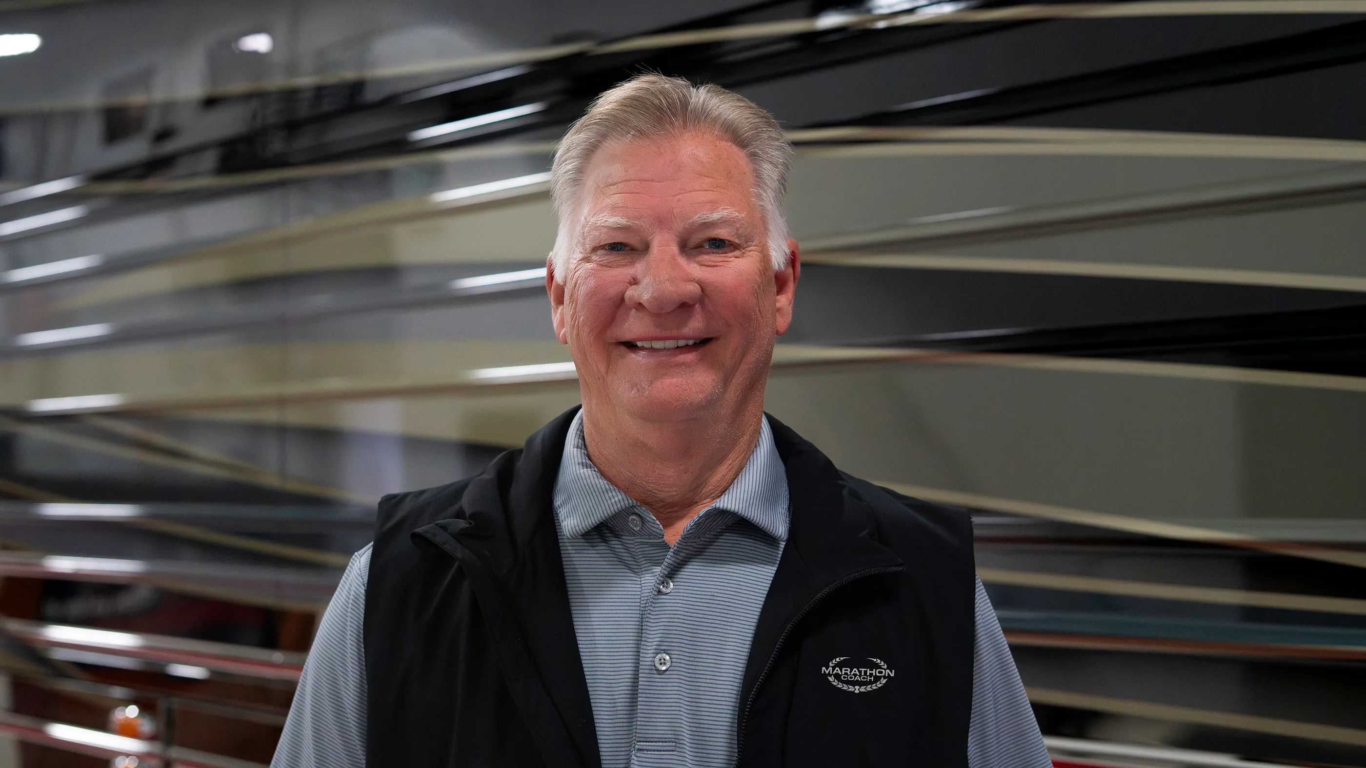 Marathon Sales Rep, Dennis McBride, poses for a portrait in front of a 2026 X3-45 chassis Prevost bus.