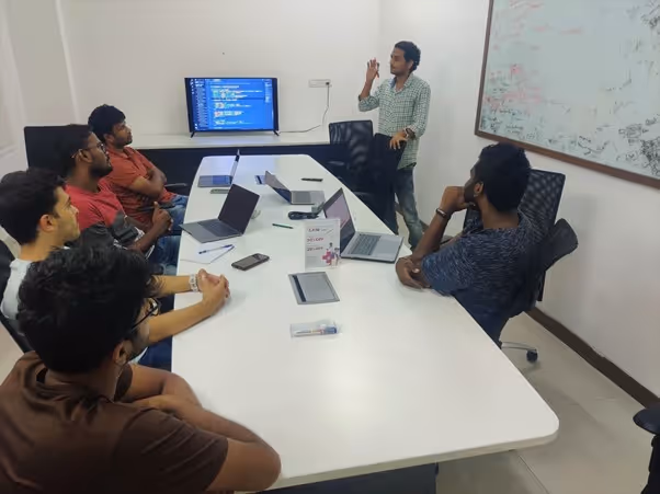 An image of a meeting featuring Raijith Shaji, co-founder and CEO of Volopay and his team during a team meeting