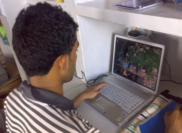 A photograph of Raijith Shaji, co-founder and CEO of Volopay as a teenager playing a computer game 