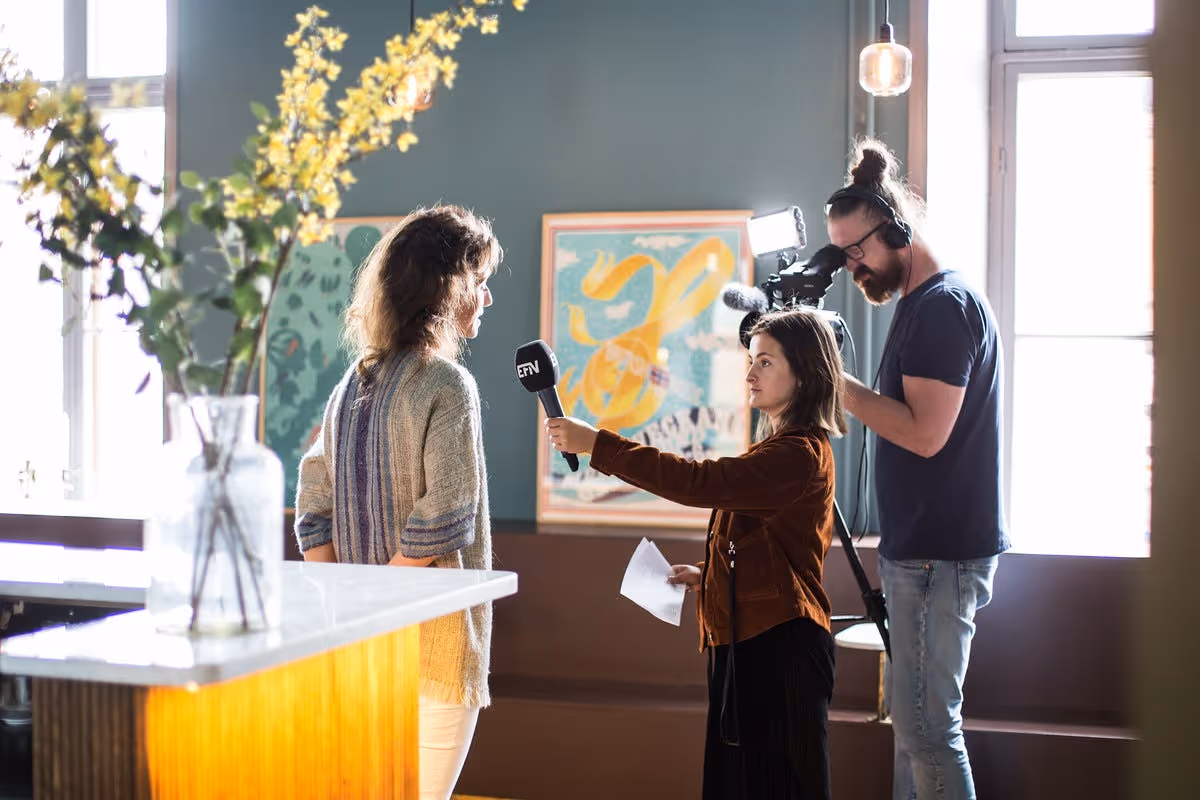 Antler representative is interviewed by a cameraman and interviewer at Stockholm's inaugural Demo Day