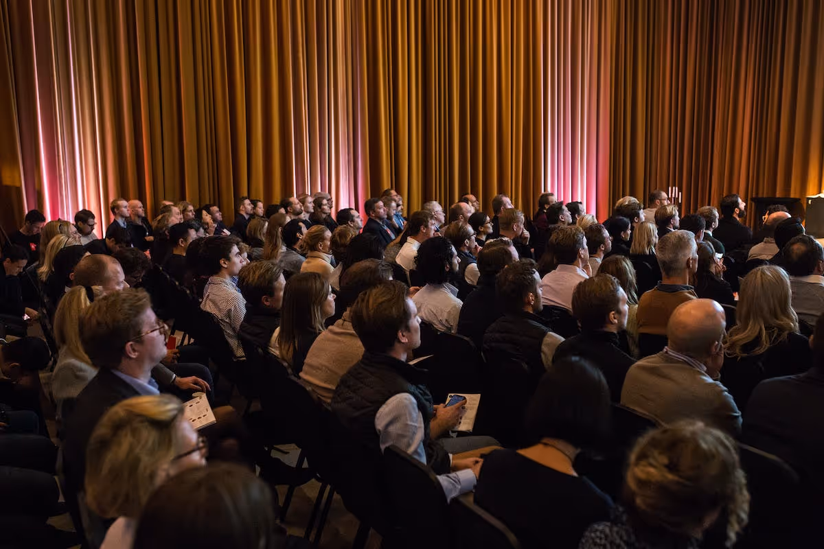 Audience sit watching presentations at Demo Day Stockholm 