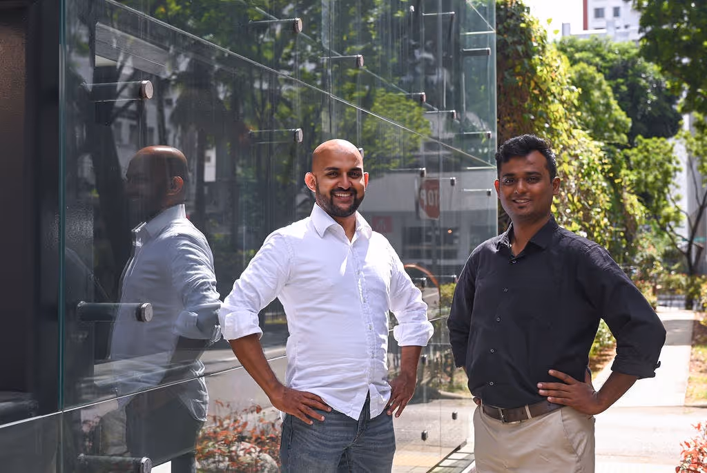 Goblin CEO Jim Nadackal and CTO Phaneendra Chiruvella pose with hands on hips outside building