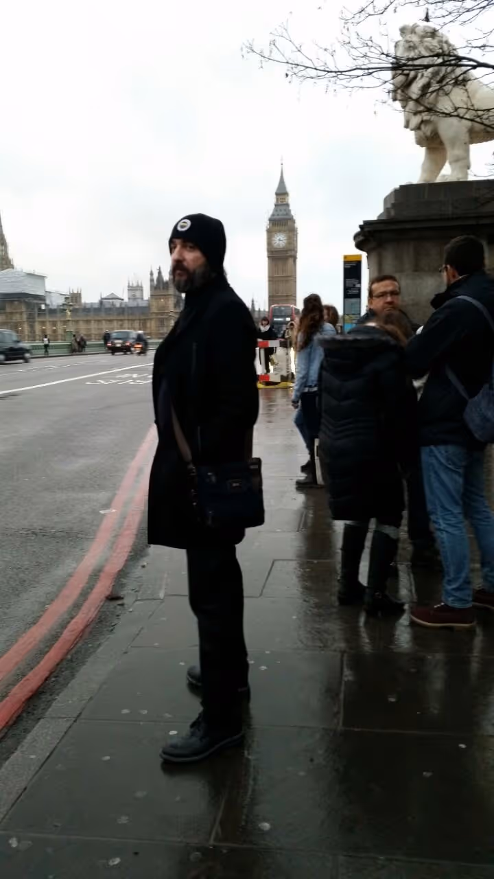 Bahadir Ozdemir stands in London Street in front of Big Ben 