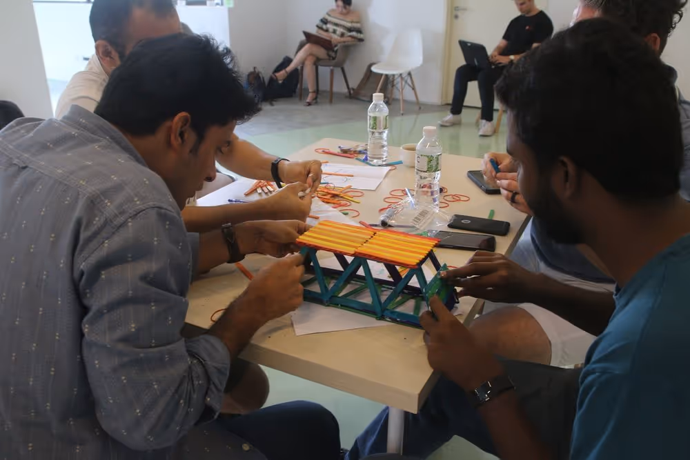 An image of Antler Demo day founders participating in a bridge building group exercise