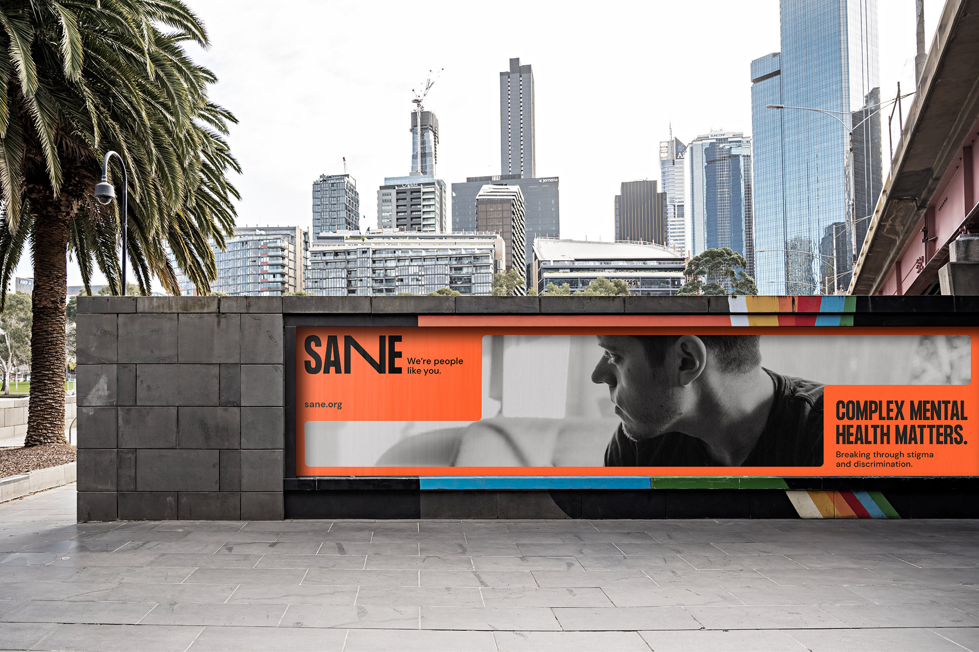 Large SANE billboard displayed in an underpass, featuring a person in distress and the headline.