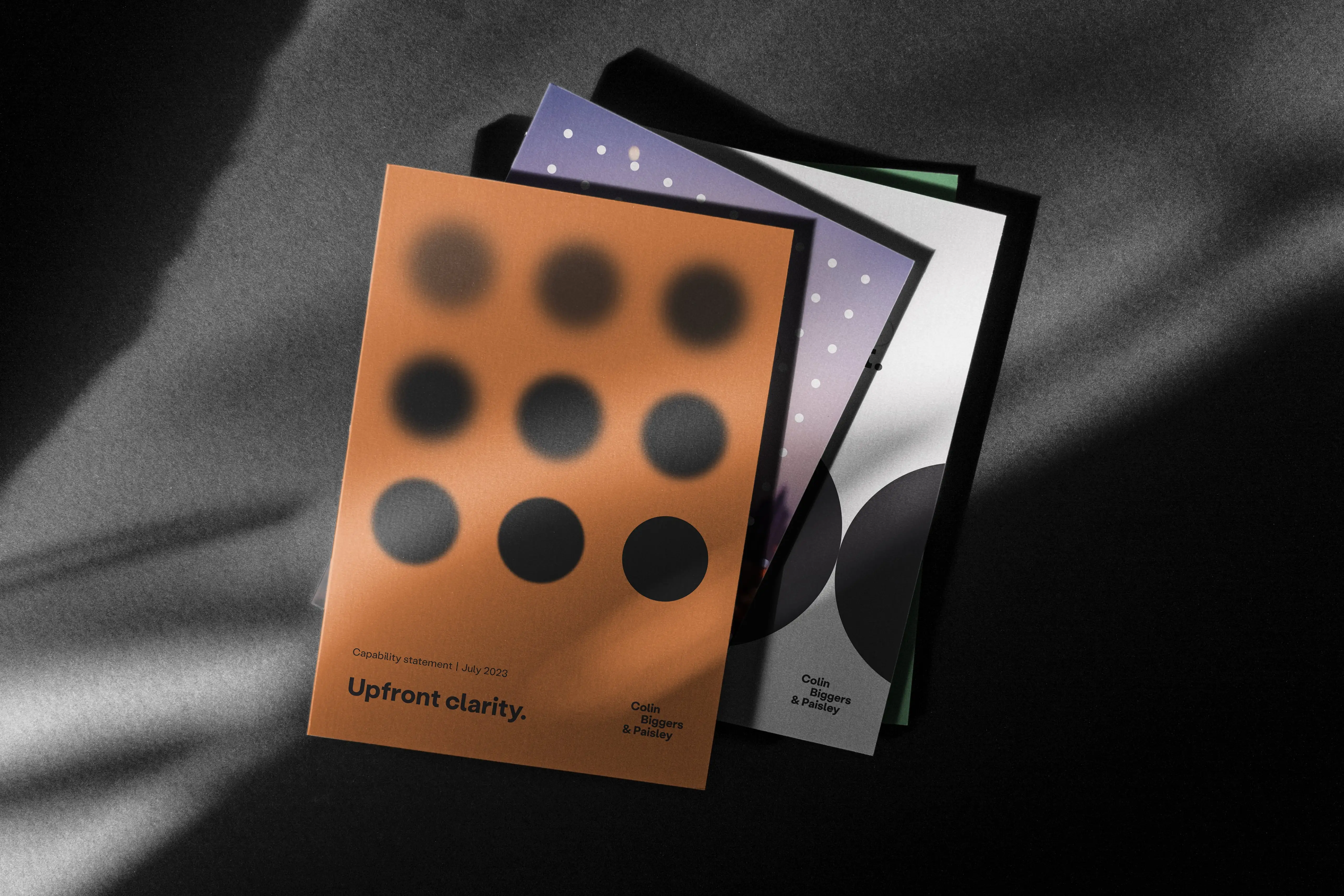 Stack of Colin Biggers & Paisley capability statement booklets.