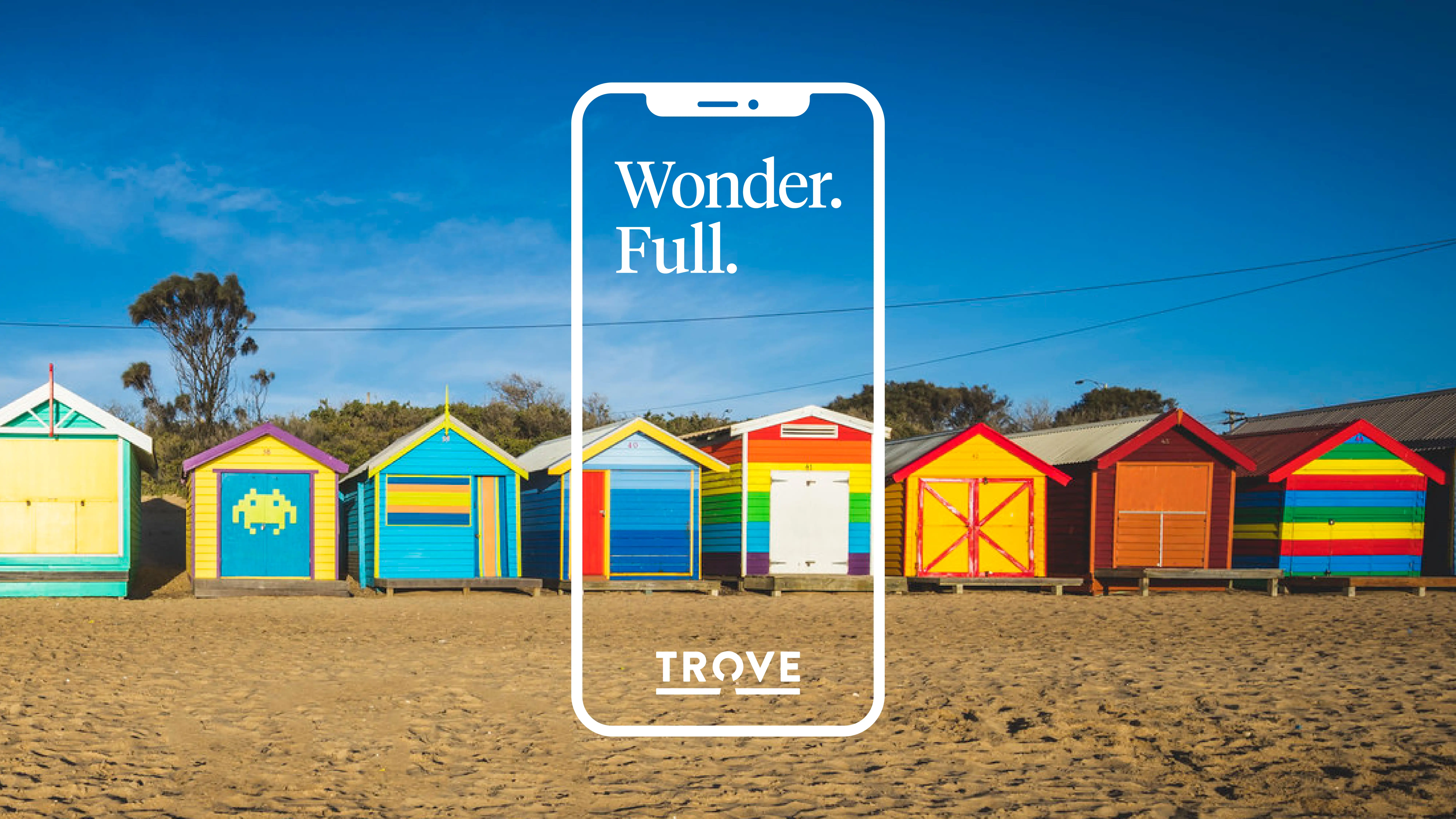 Photo of colourful beach huts with a white smartphone outline overlay and the headline ‘Wonder. Full.’ in the center, representing the Trove brand experience.