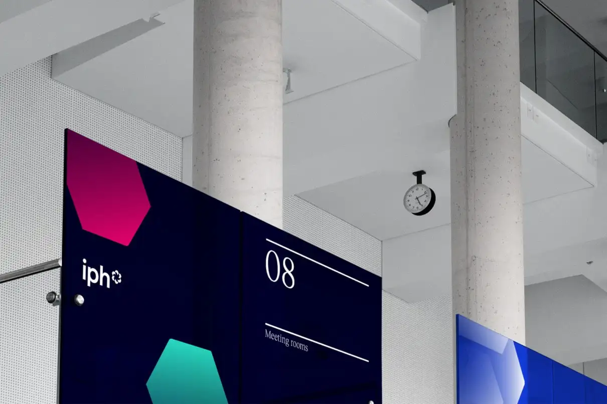 IPH signage system applied in workplace environments, demonstrating the refreshed visual identity.