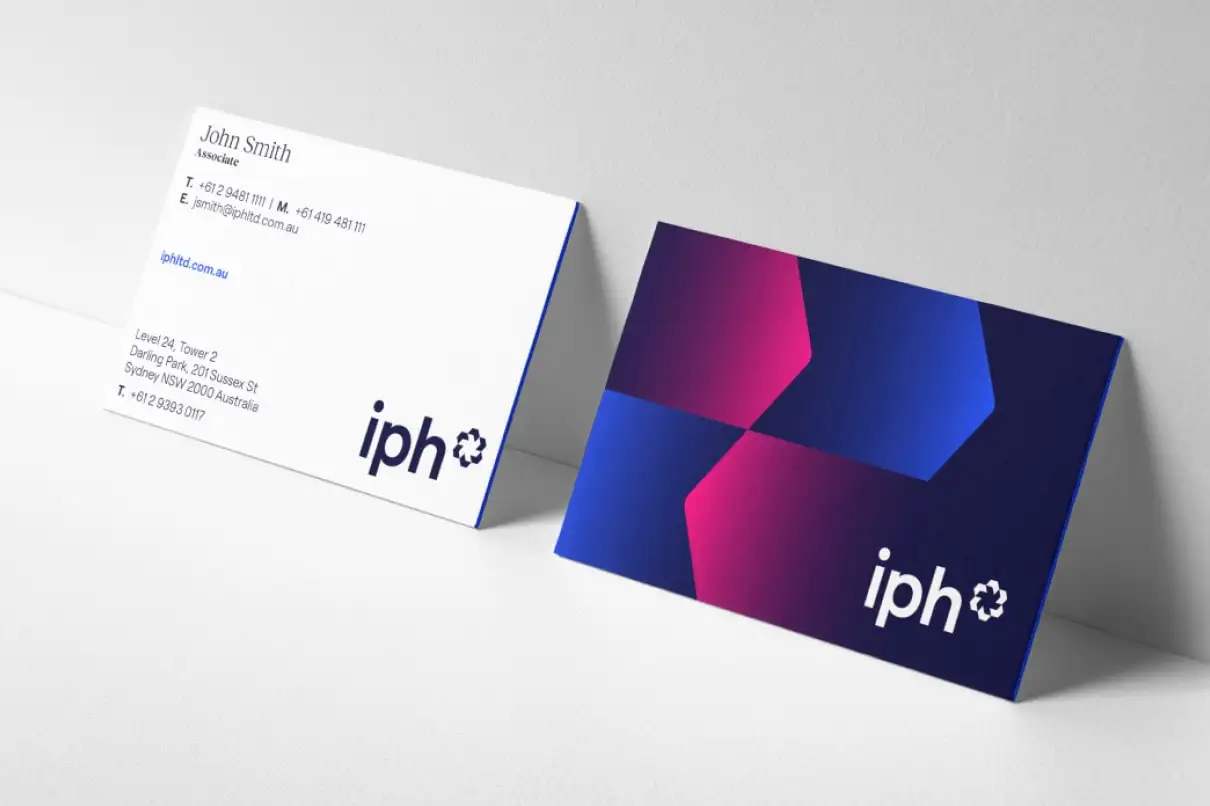 IPH business cards featuring the refreshed identity with bold geometric graphics.