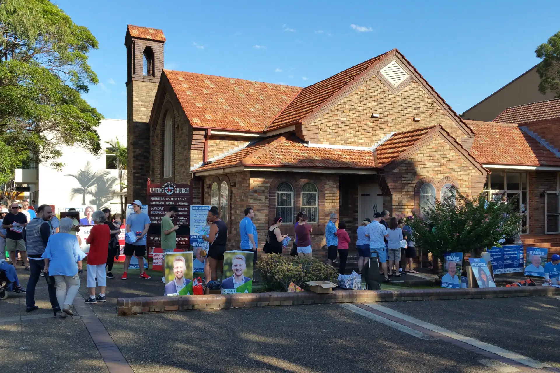 Voters gathering outside a suburban polling place, illustrating on-the-ground election day experiences.