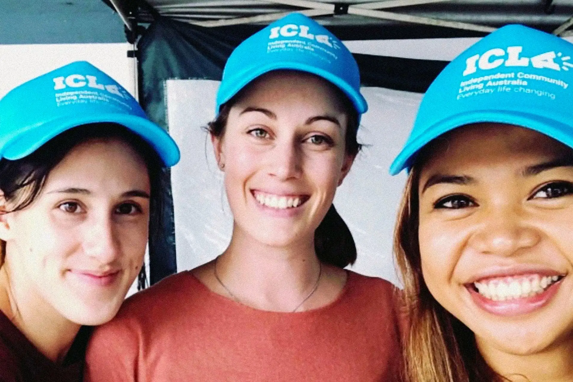 ICLA team members wearing new branded hats, demonstrating staff pride and adoption of the refreshed identity.