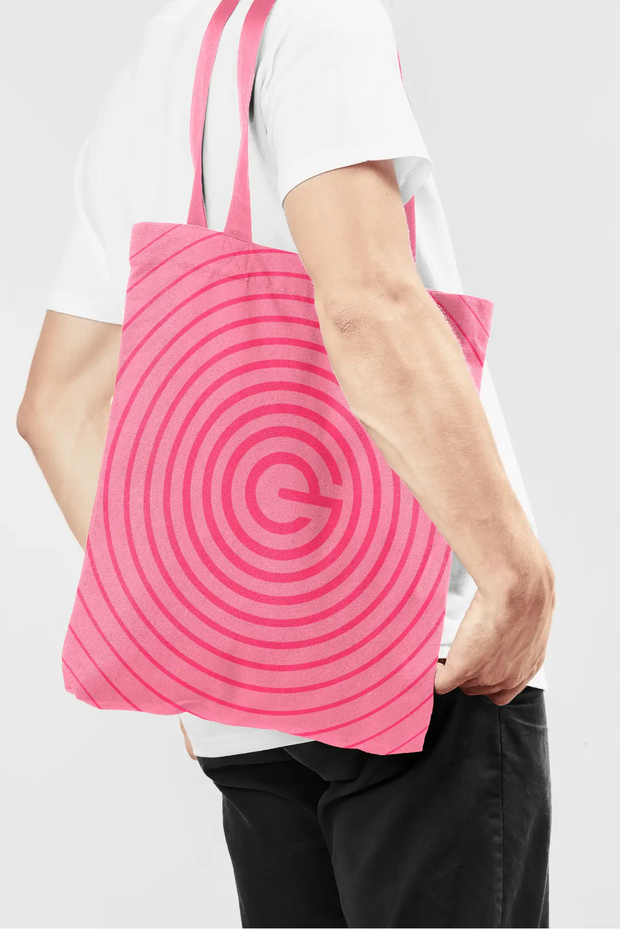 Person carrying a pink tote bag with EduGrowth branding applied.
