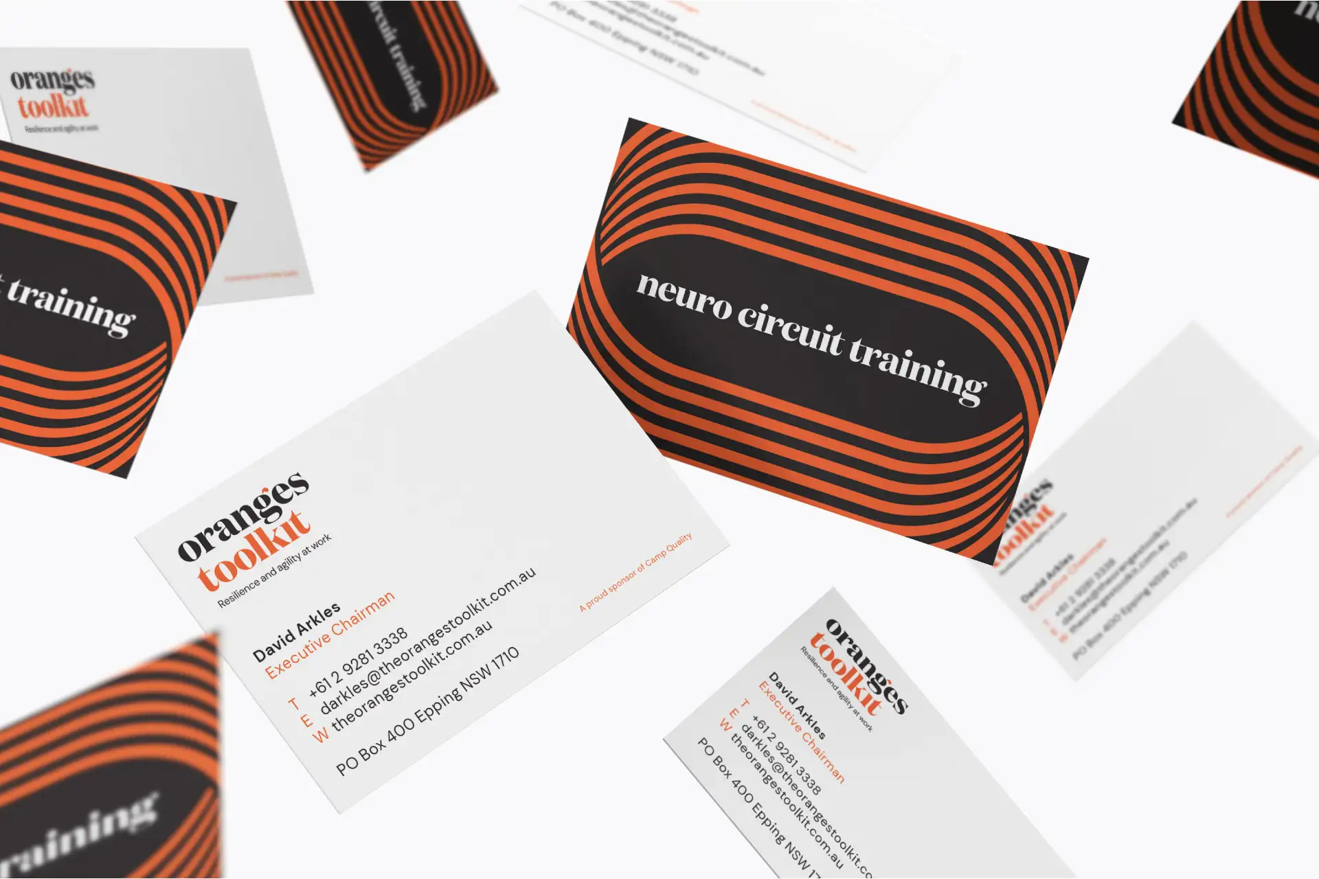 Business cards for Oranges Toolkit with orange and black striped design.