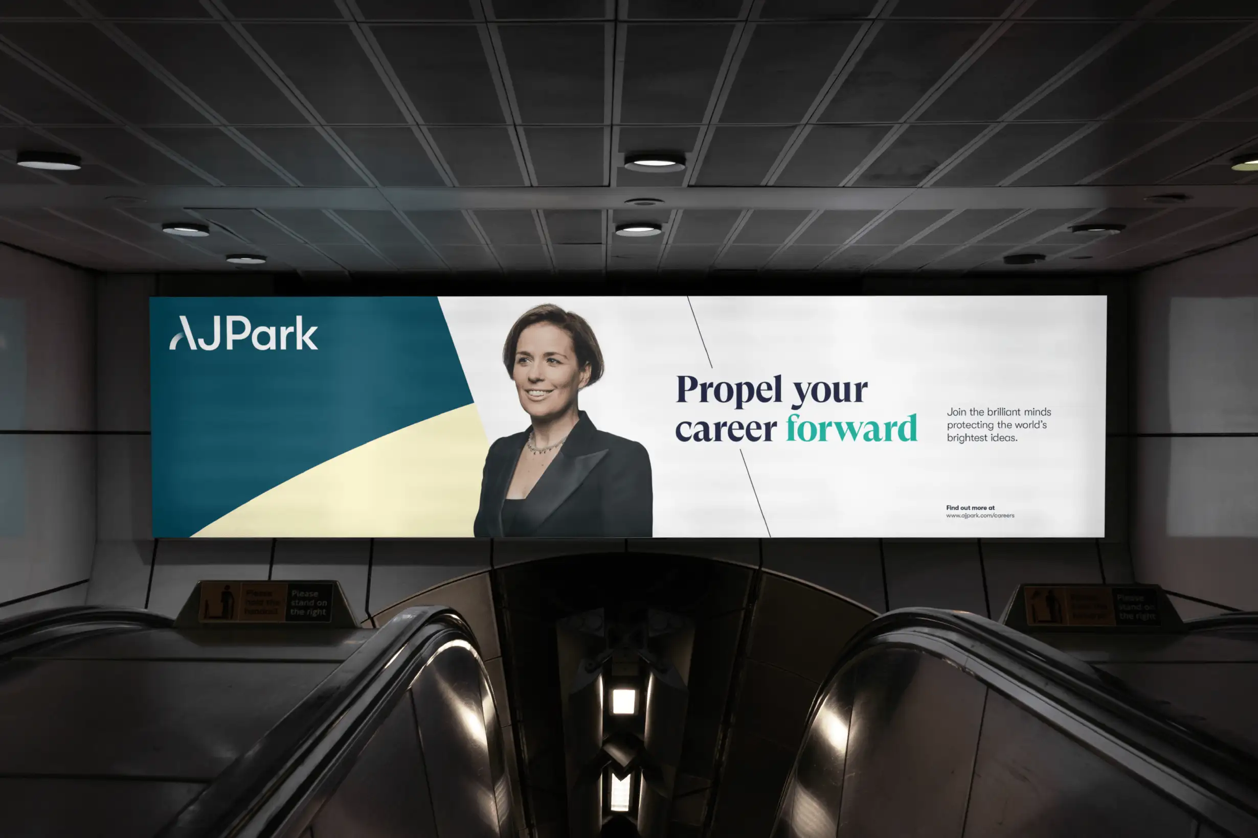 Large transit billboard featuring the AJ Park logo, a photographed staff member, and the message “Propel your career forward.”