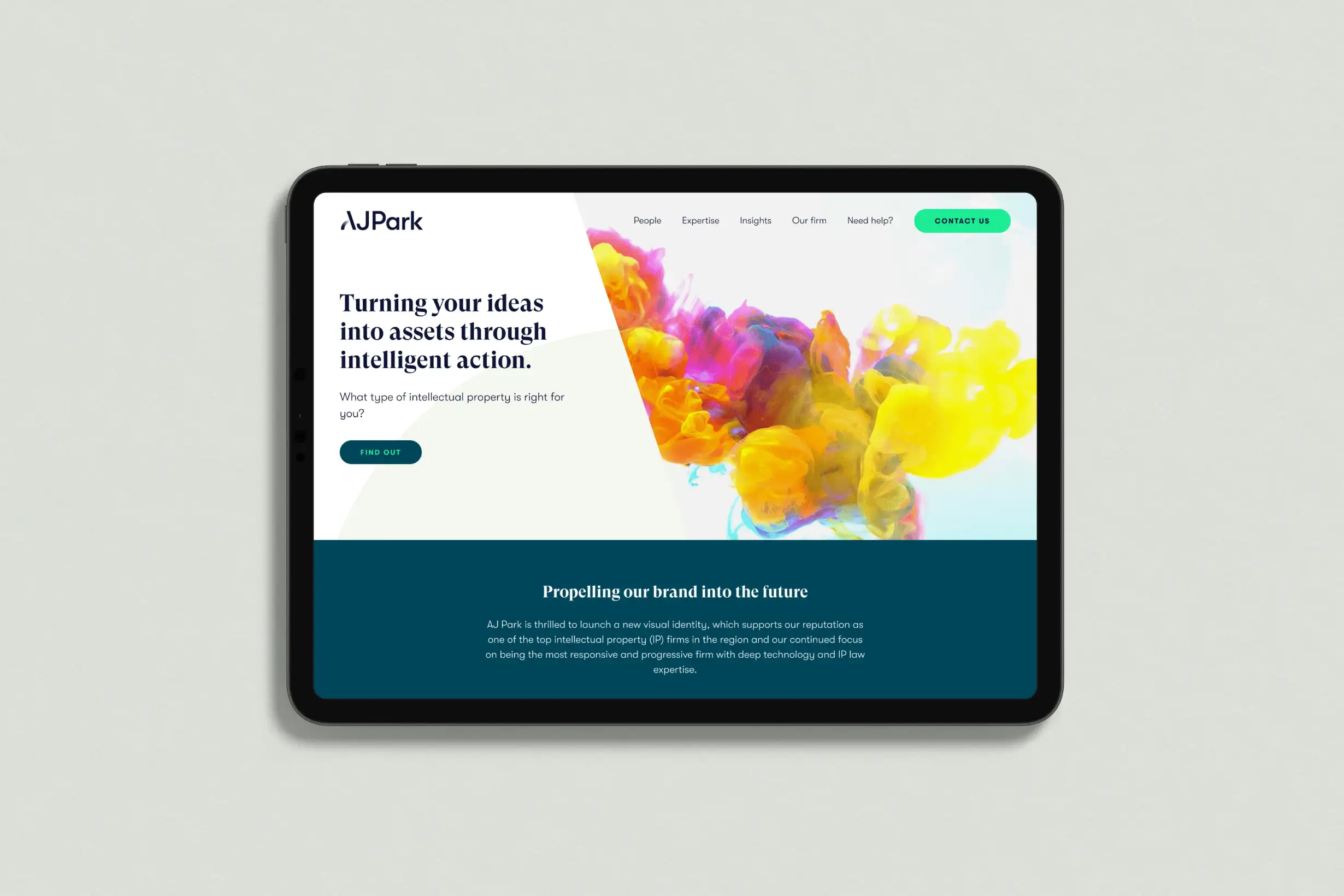 Tablet displaying the AJ Park homepage with the headline “Turning your ideas into assets through intelligent action” and colourful ink cloud artwork.