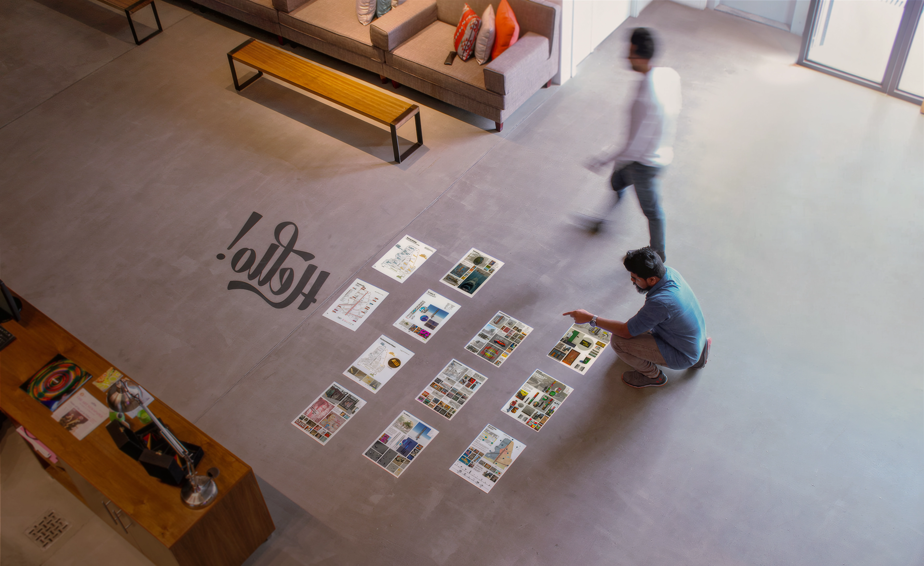 Aerial view of the LIMAH design team reviewing strategy printouts during a planning session