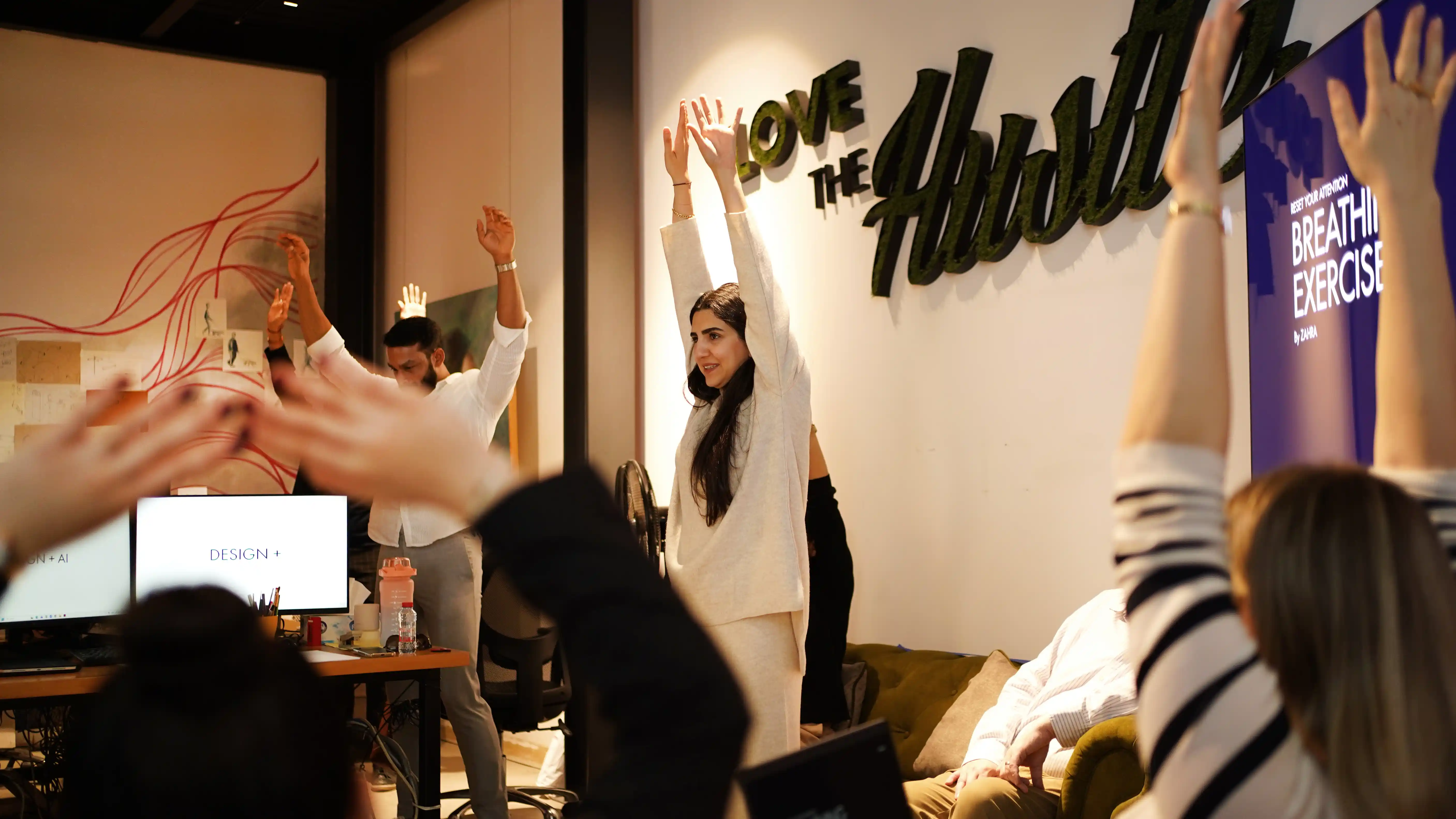 LIMAH's diverse design team doing a breathing exercise during their Monday morning hurdle