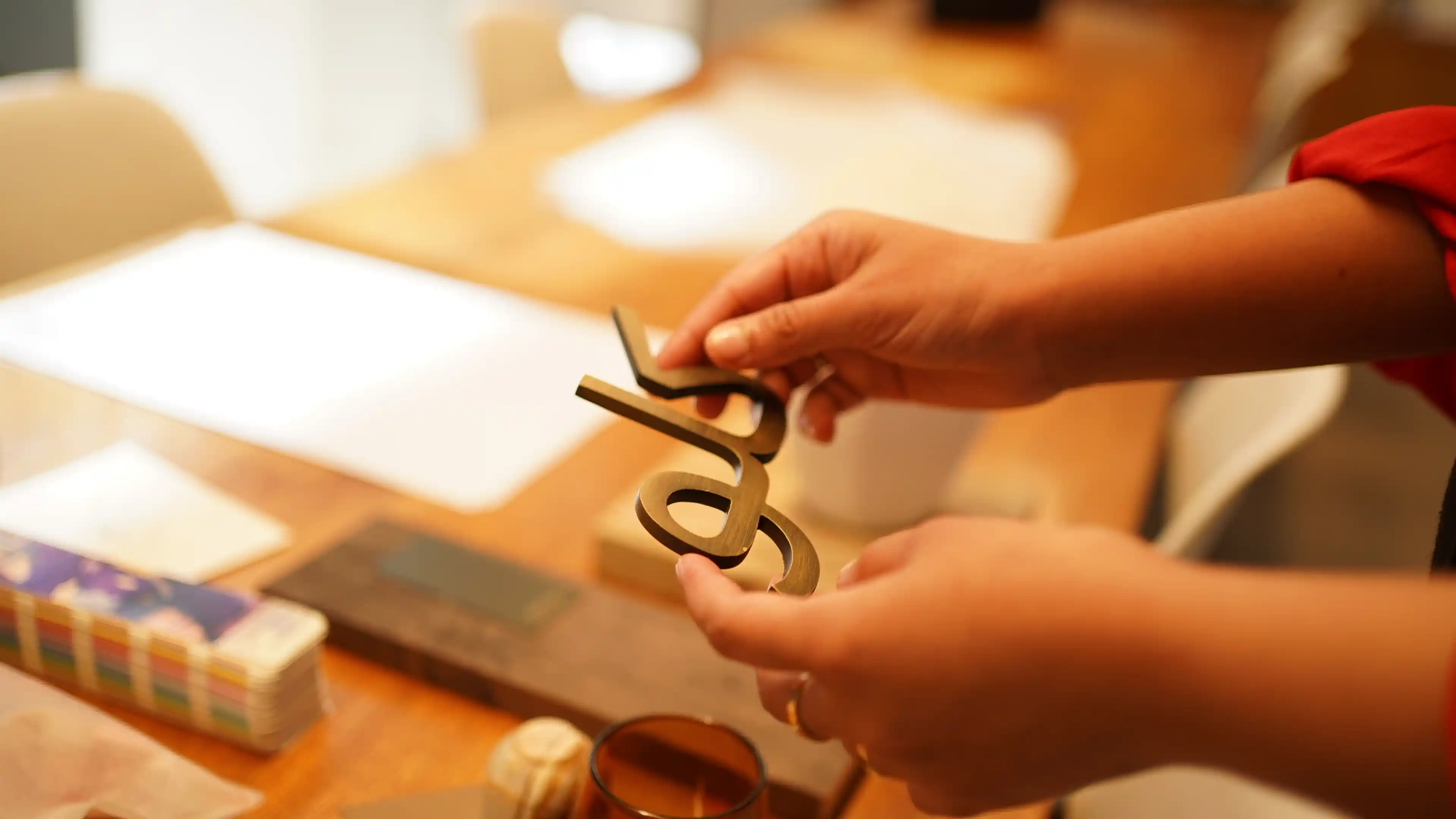 Close up of a LIMAH designer holding an Arabic text sample for technical delivery