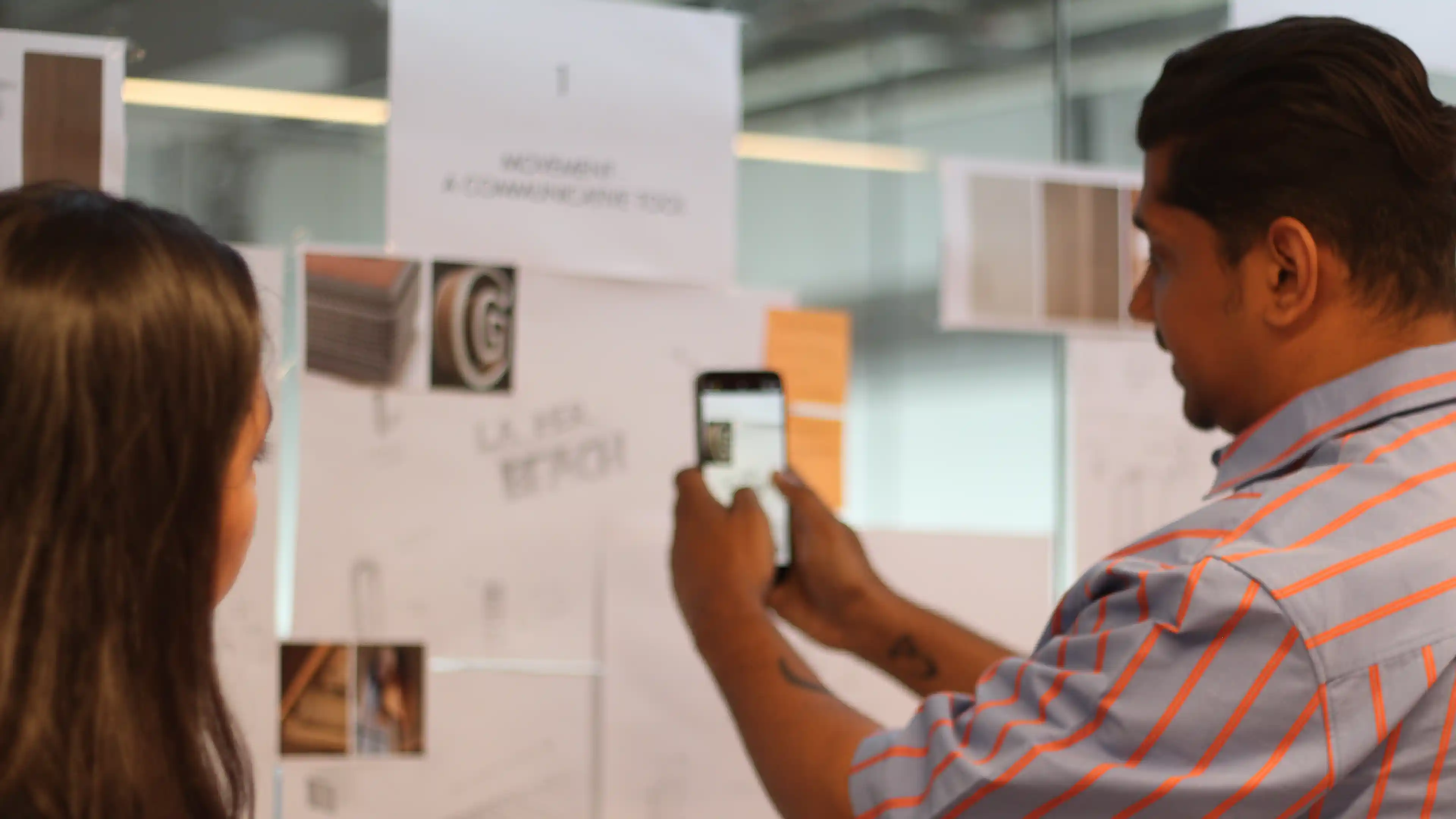 LIMAH designer and Director of Experiential and Wayfinding reviewing strategy on a mobile device
