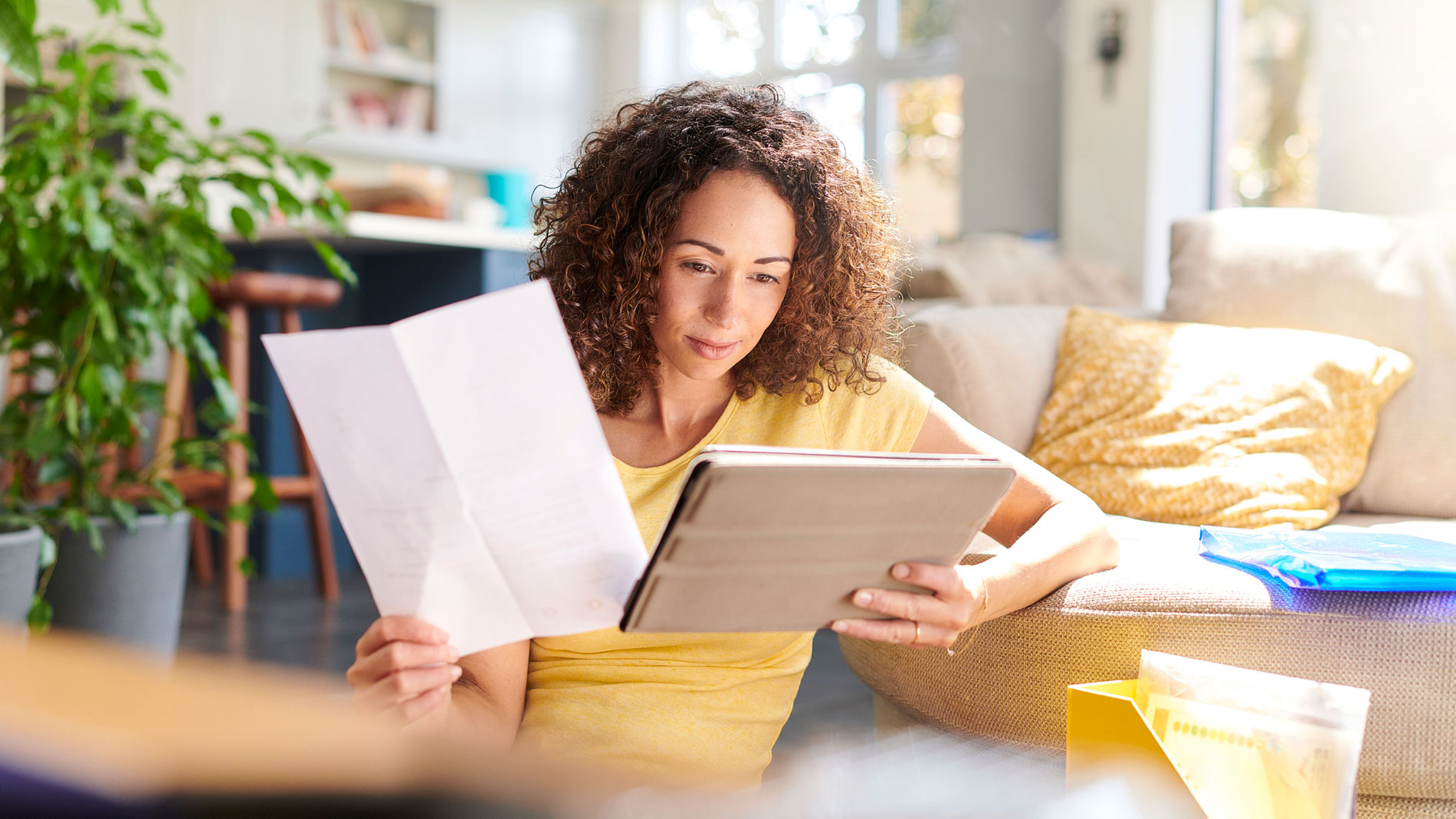 Woman with iPad and invoice
