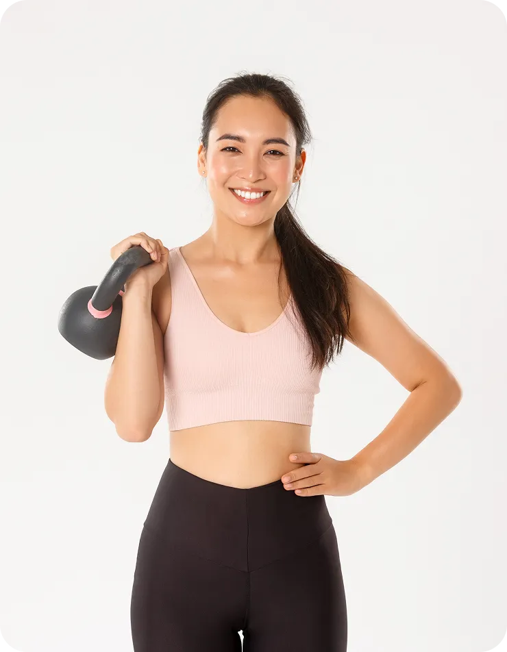 A woman in a pink top and black leggings.