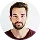 A man with a beard is looking at the camera.