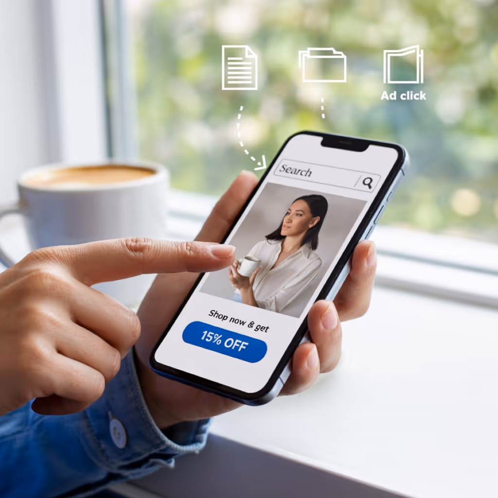 Person holding smartphone showing an ad with a woman holding a coffee cup and a button labeled ‘Shop Now & Get 19% Off’ with illustration of ad click tracking.