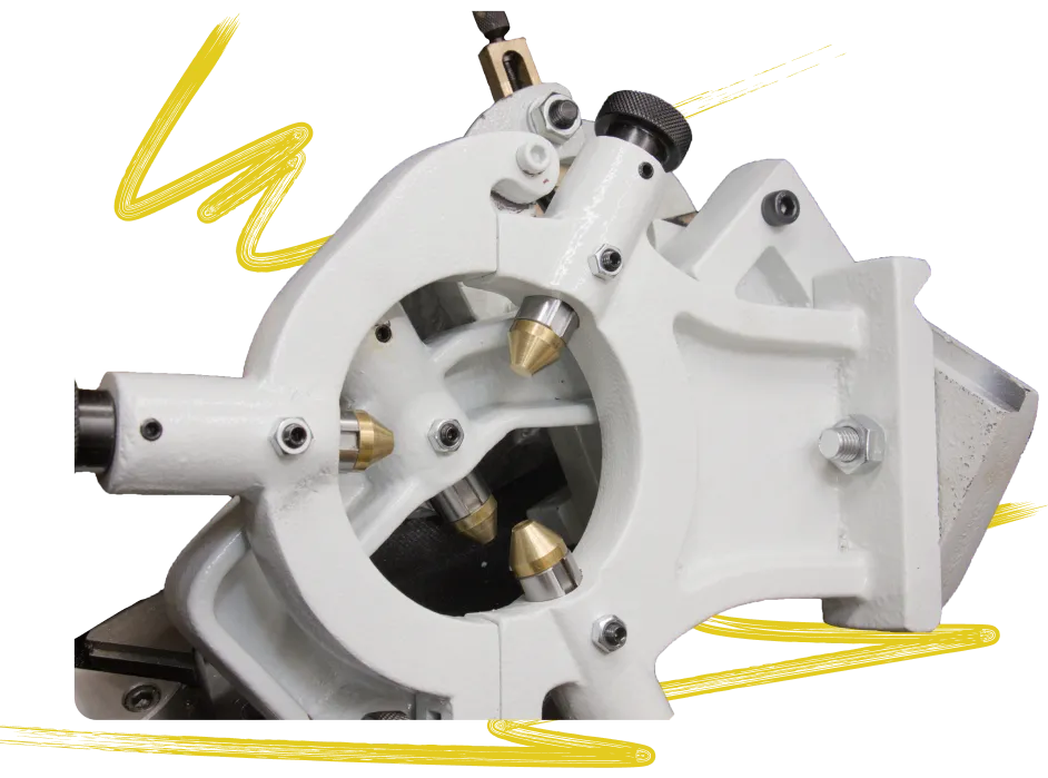 Specialized light gray machining fixture with precision brass components, illustrating the complexity of custom fabrication and prototyping tools available inside the Flatirons Rapid Prototyping workshop.