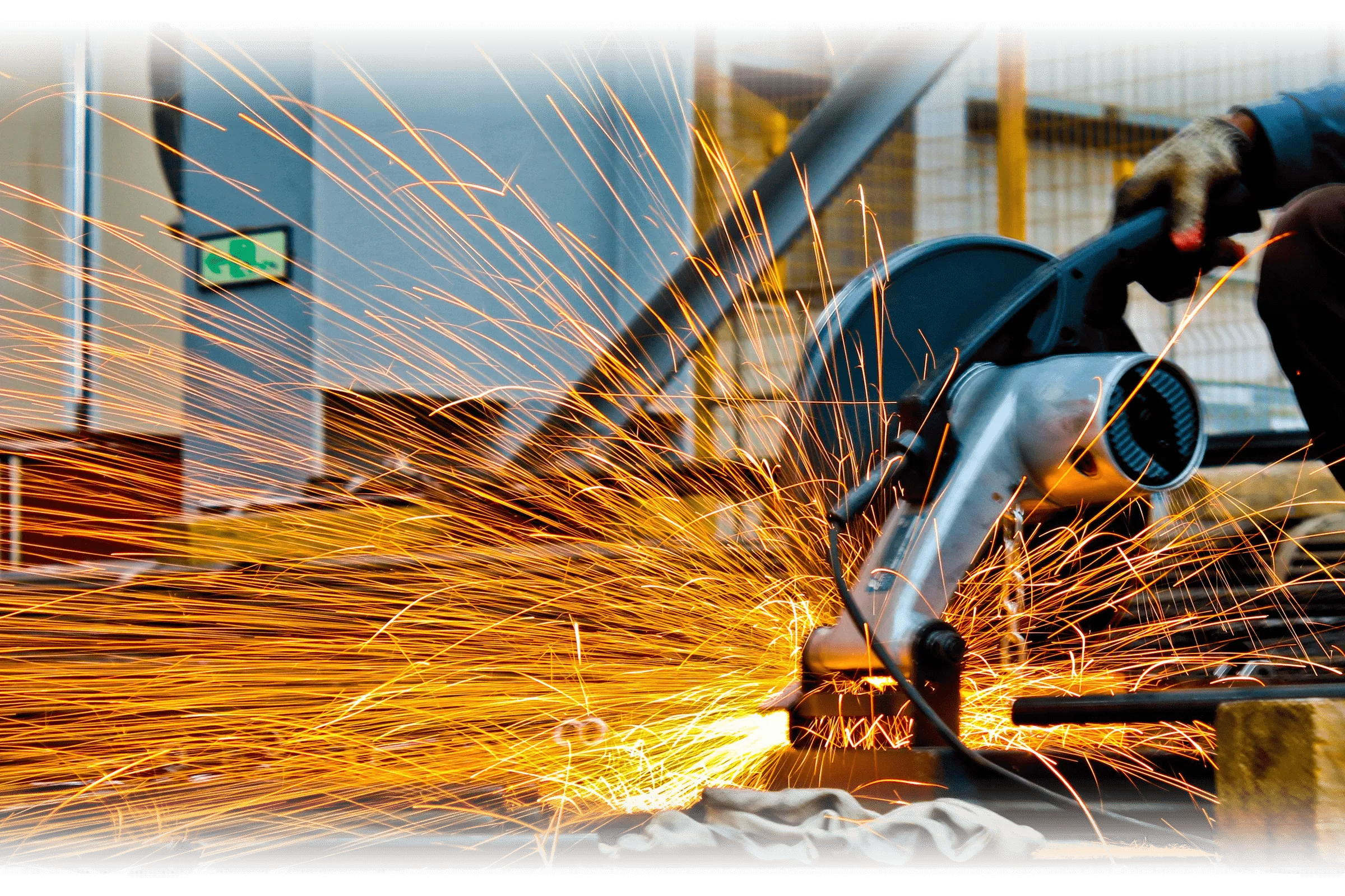 A dramatic close-up of a welder wearing a mask, with bright sparks flying, highlighting Flatirons Rapid Prototyping's welding and fabrication services.