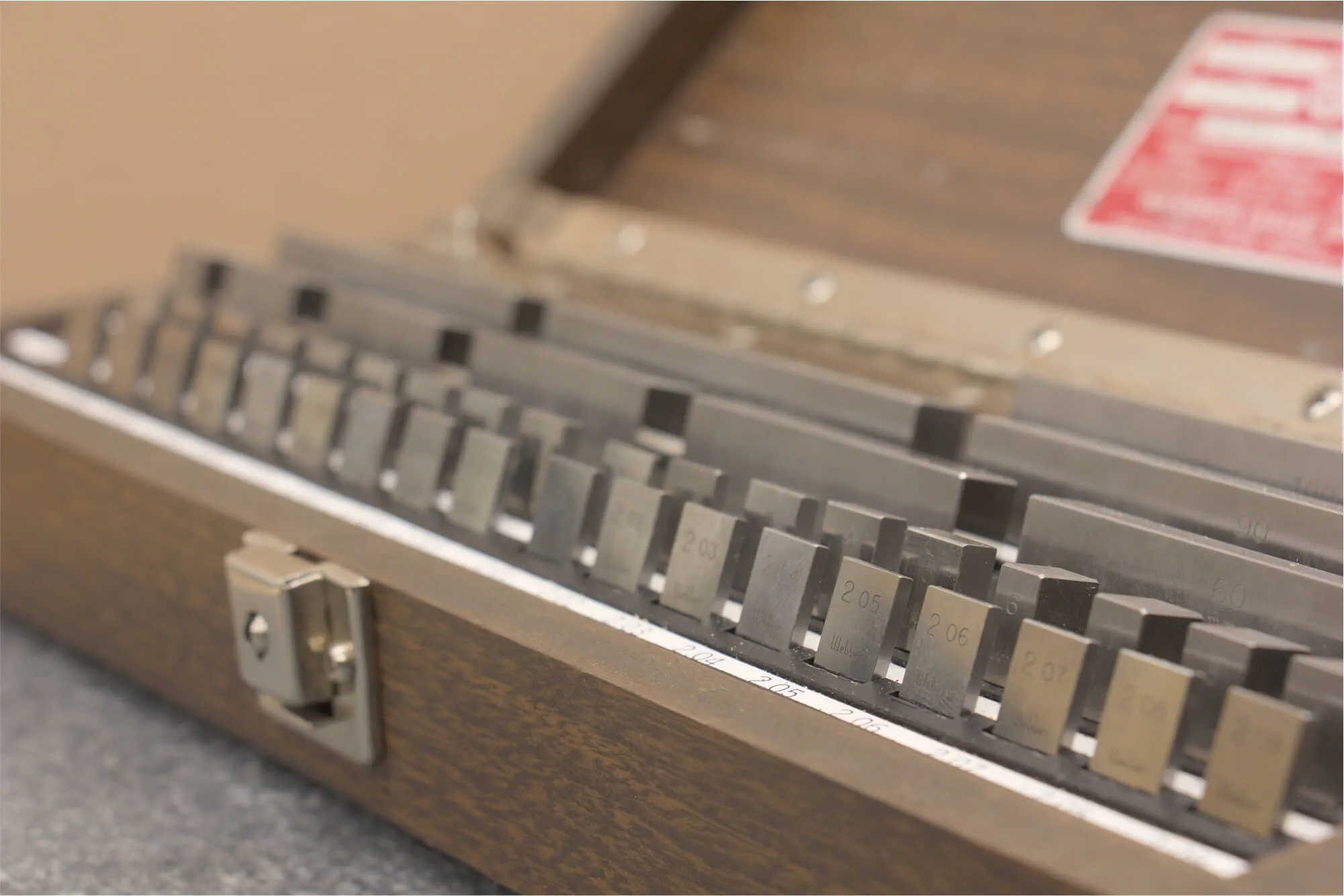 A set of meticulously organized precision gauge blocks in their case, demonstrating the commitment to quality control and precise measurement for every fabricated prototype.