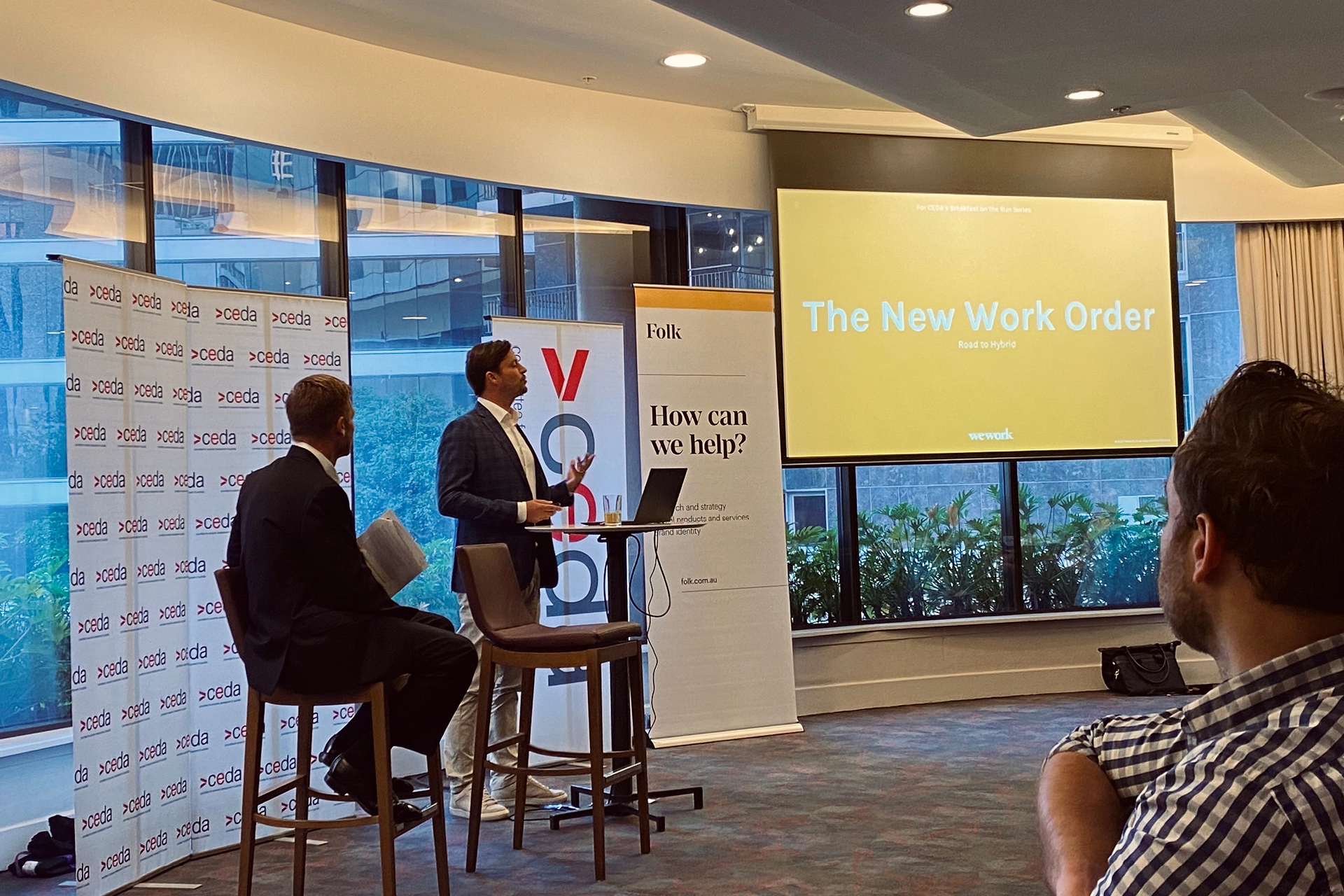 WeWork event speaker presenting future-of-work trends to an audience, highlighting shifts in workplace expectations.