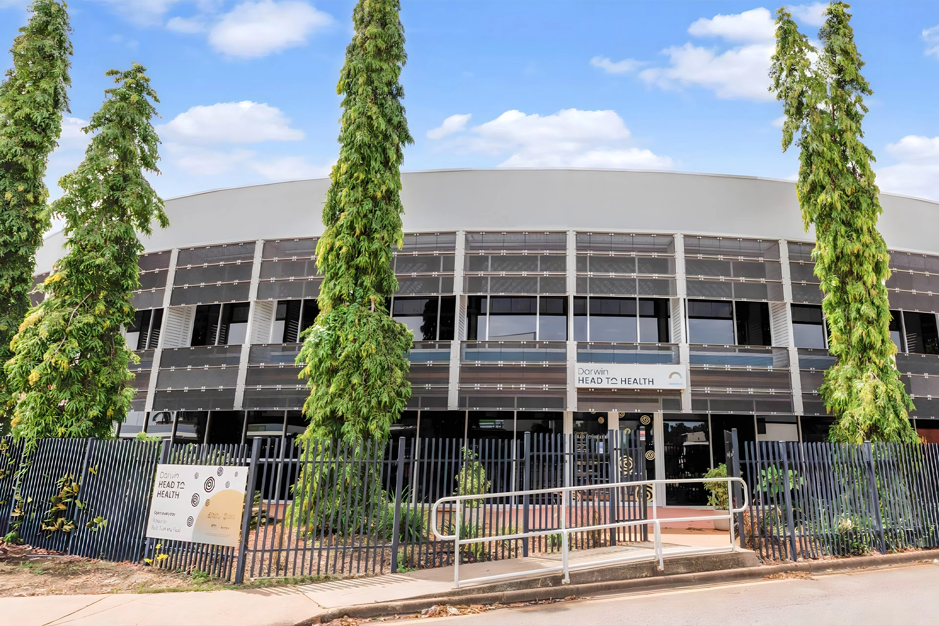 Exterior of the Darwin Head to Health centre, showing the curved building façade.