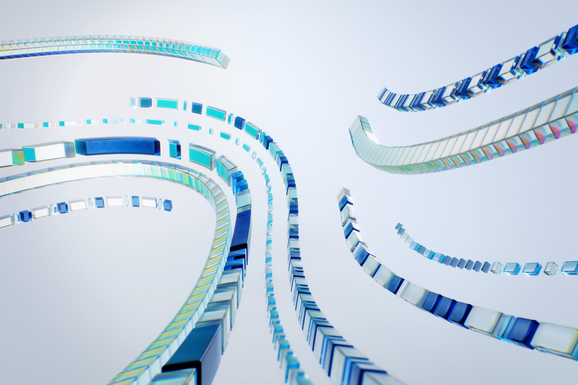 Curved paths made of small blue and clear glass-like blocks against a light background.