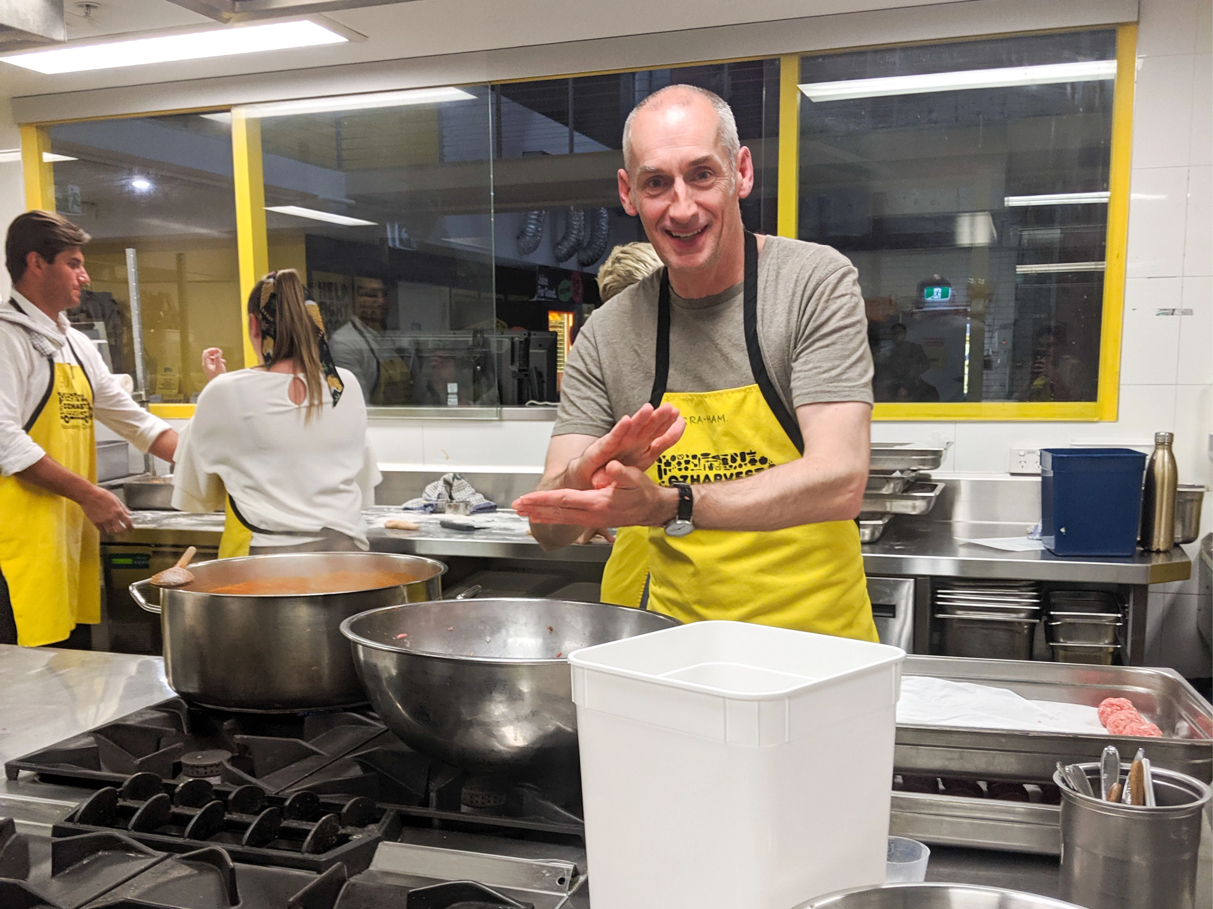 A Folk team member shaping food by hand in the kitchen during the Cooking for a Cause event.