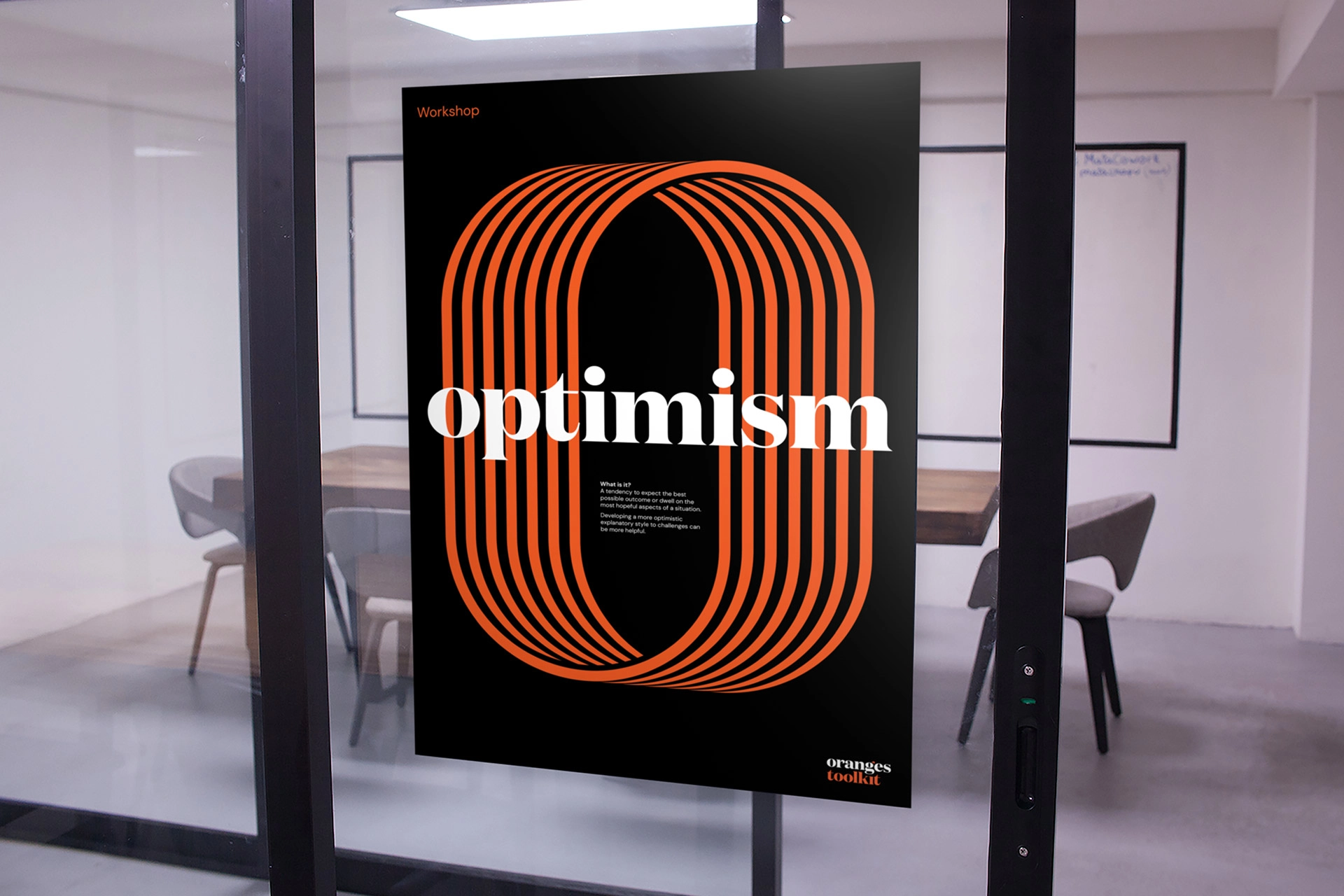 A poster from the Oranges Toolkit titled “optimism,” featuring an orange graphic “O” displayed on a meeting-room glass wall.