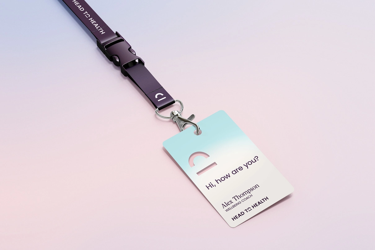 Head to Health lanyard and ID card reading “Hi, how are you?” for wellbeing coach Alex Thompson.