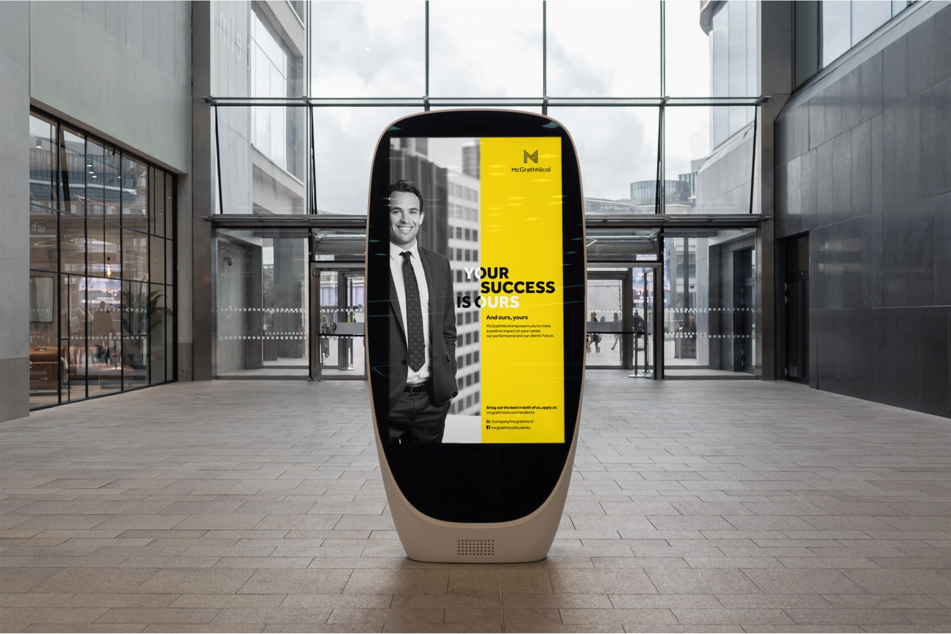 McGrathNicol graduate campaign shown on a yellow digital street kiosk display in an urban setting.