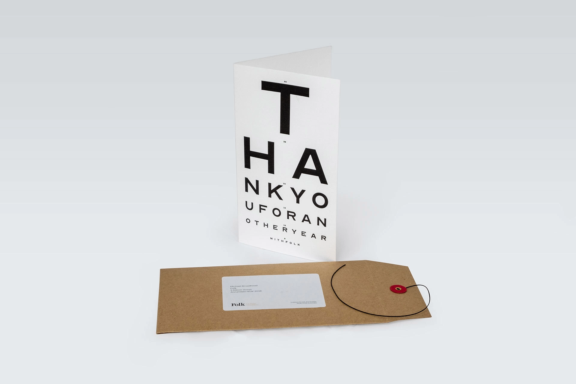 The optometrist-style card displayed with a kraft envelope.