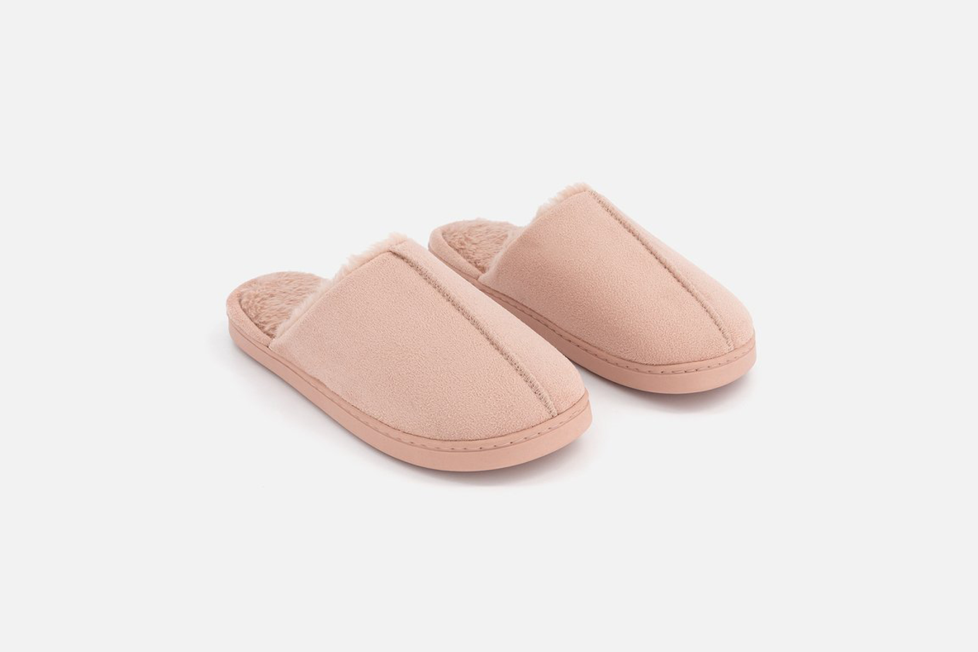 Pair of soft pink house slippers representing the shift toward comfort and hybrid work culture.